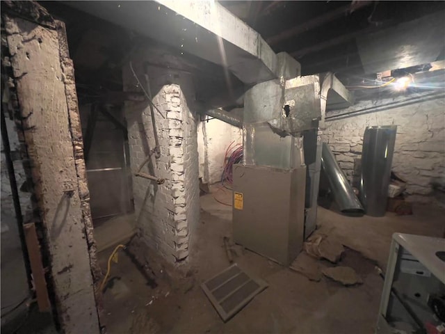 utility room featuring heating unit