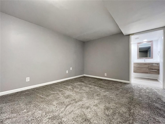 spare room with sink and carpet flooring