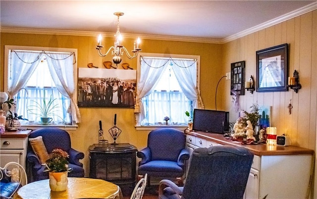 living area with a wealth of natural light, crown molding, wood walls, and a notable chandelier