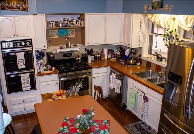 kitchen featuring white cabinets, dark hardwood / wood-style floors, and stainless steel appliances