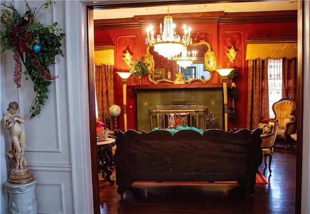 sitting room featuring wood-type flooring and an inviting chandelier