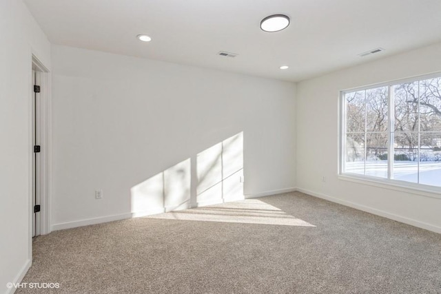 unfurnished room with light carpet