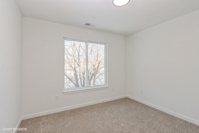 unfurnished room featuring light colored carpet