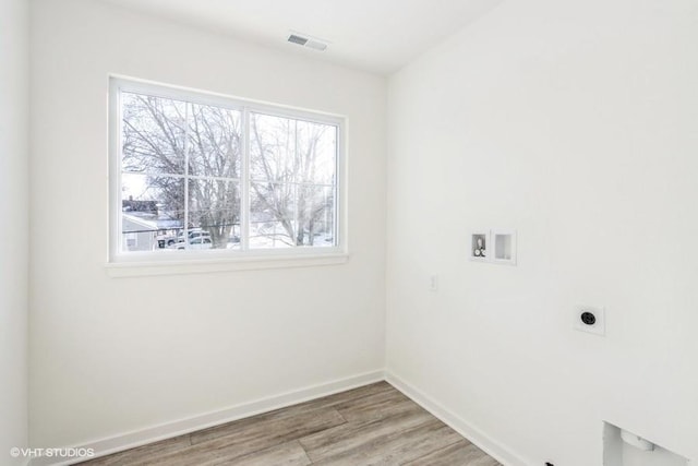 laundry area with electric dryer hookup, washer hookup, and hardwood / wood-style flooring