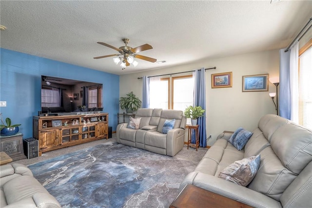 carpeted living room with a textured ceiling and ceiling fan