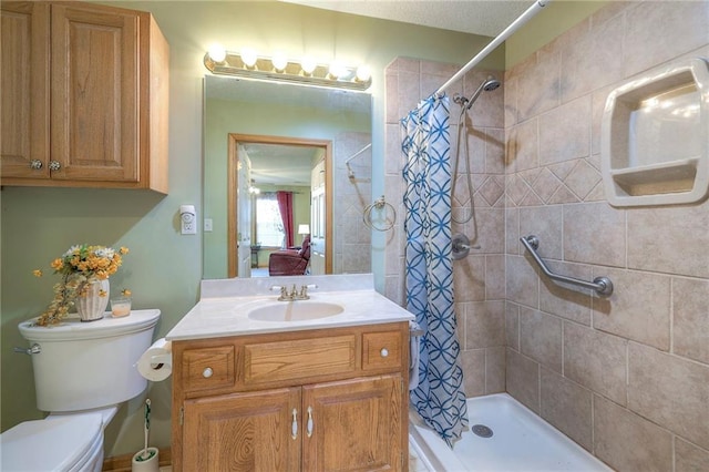 bathroom featuring vanity, a shower with shower curtain, and toilet