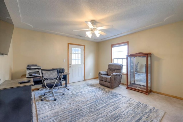 office space with ceiling fan, light carpet, and a textured ceiling