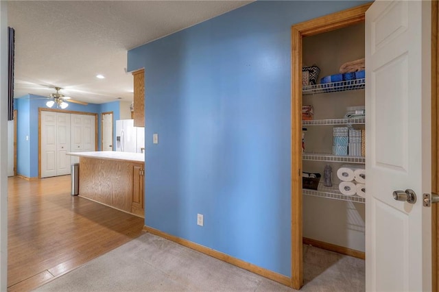 hallway with light hardwood / wood-style floors