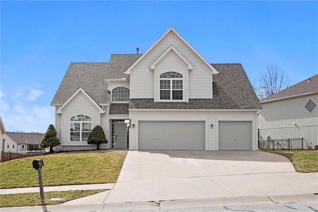 traditional home featuring concrete driveway, roof with shingles, a front yard, and fence