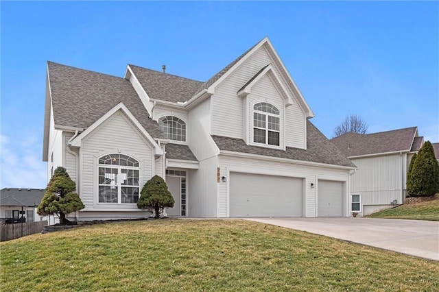 traditional home featuring an attached garage, roof with shingles, driveway, and a front lawn