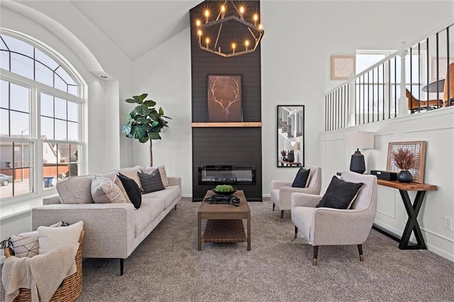 living area featuring carpet floors, high vaulted ceiling, a fireplace, and baseboards