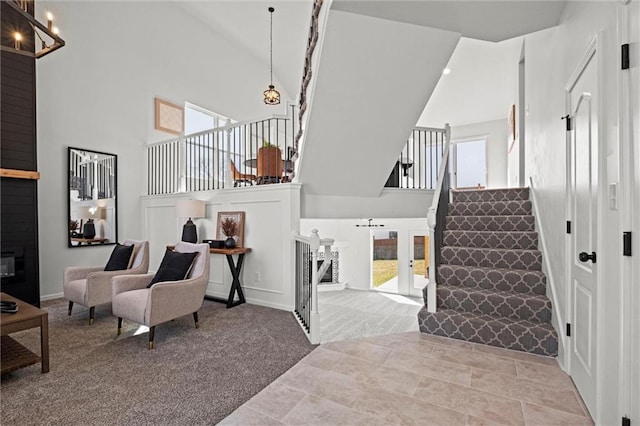 interior space featuring an inviting chandelier, stairs, and high vaulted ceiling