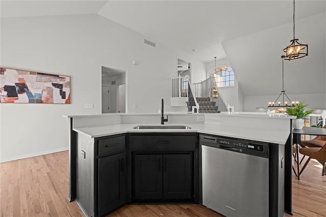 kitchen featuring a sink, visible vents, light countertops, stainless steel dishwasher, and an inviting chandelier