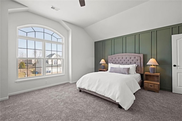 bedroom with a ceiling fan, visible vents, vaulted ceiling, and carpet flooring