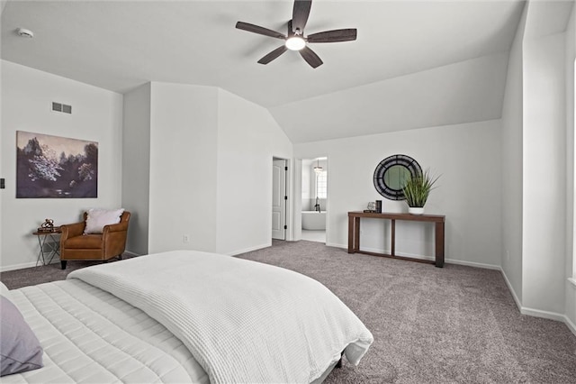 carpeted bedroom featuring visible vents, ensuite bathroom, vaulted ceiling, ceiling fan, and baseboards