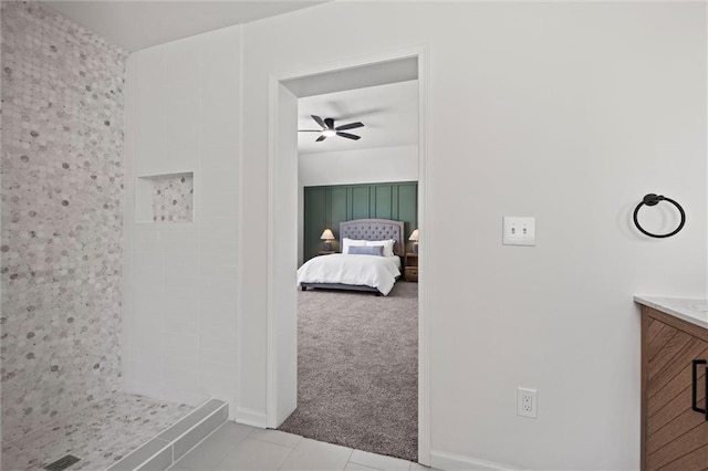 tiled bedroom featuring ceiling fan and carpet flooring