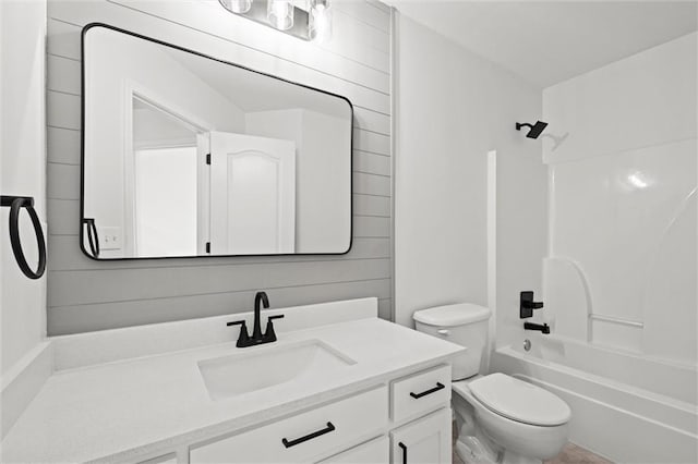 full bath with bathtub / shower combination, vanity, and toilet