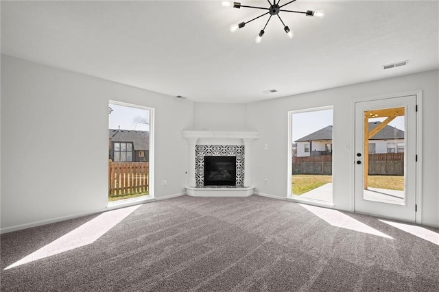 unfurnished living room featuring baseboards, carpet, visible vents, and a tiled fireplace