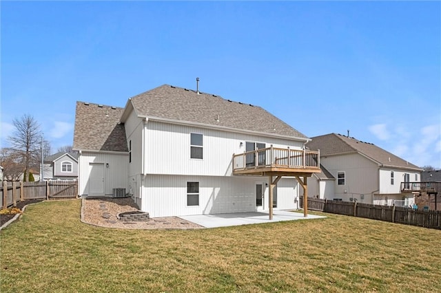 rear view of property with roof with shingles, a yard, a patio, central AC, and a fenced backyard