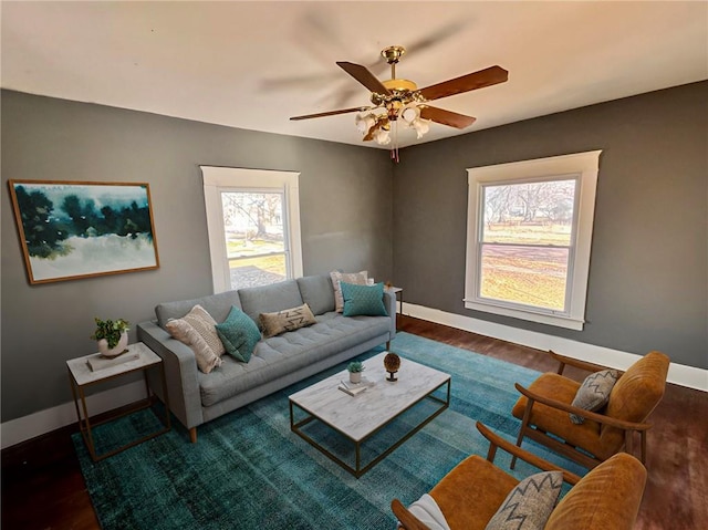 living room with ceiling fan and dark hardwood / wood-style floors