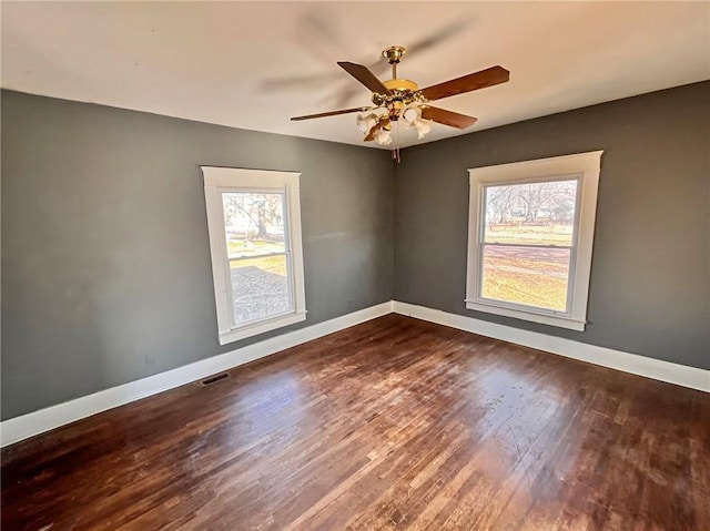 spare room featuring hardwood / wood-style floors and ceiling fan