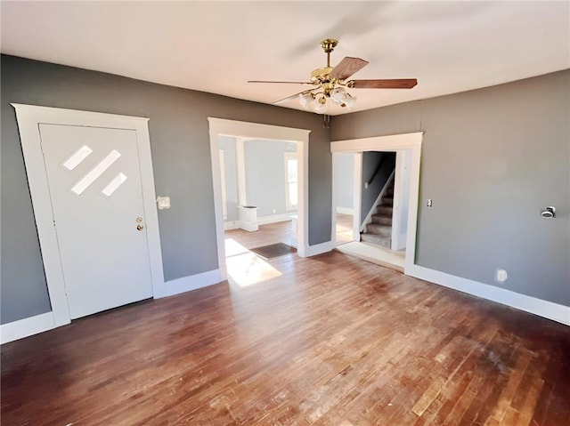 entrance foyer with ceiling fan and wood-type flooring