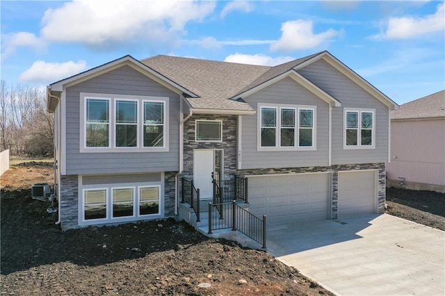 raised ranch with a garage and central AC