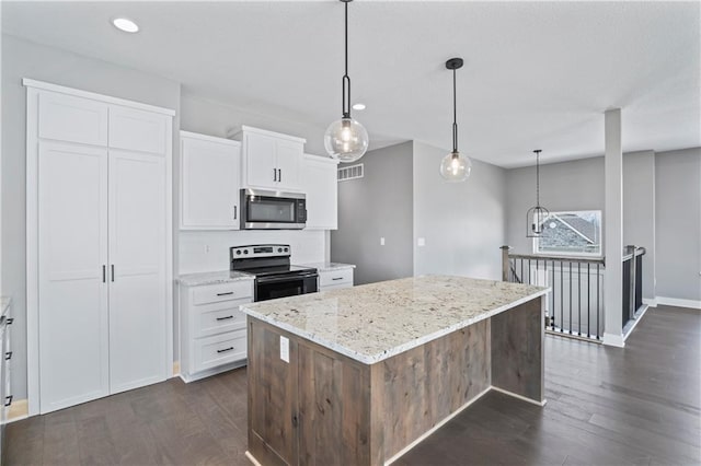 kitchen with white cabinetry, light stone counters, a kitchen island, electric stove, and pendant lighting