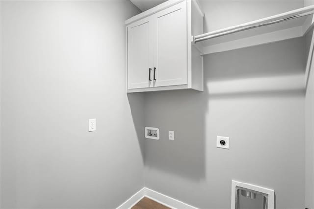 washroom with hookup for a washing machine, cabinets, and hookup for an electric dryer