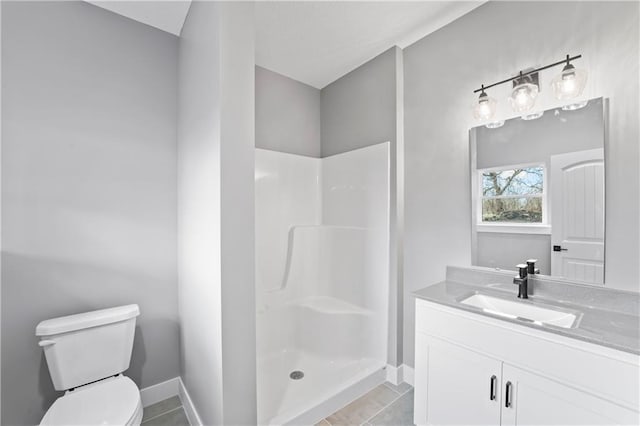 bathroom with toilet, tile patterned flooring, a shower, and vanity