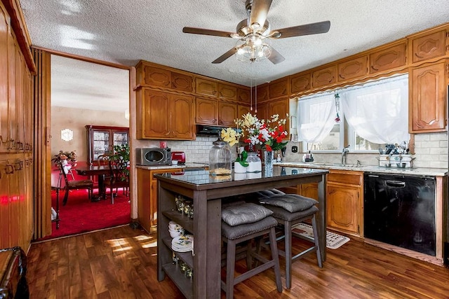 kitchen with ceiling fan, decorative backsplash, black dishwasher, dark wood-type flooring, and a textured ceiling