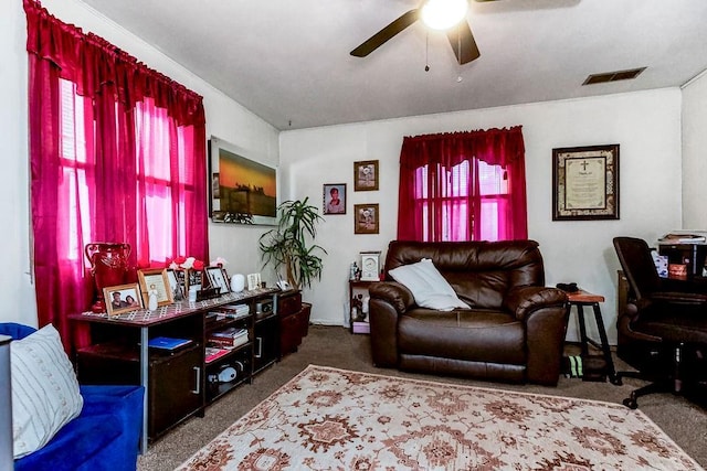 carpeted living room featuring ceiling fan