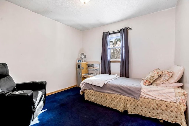 bedroom featuring carpet and a textured ceiling