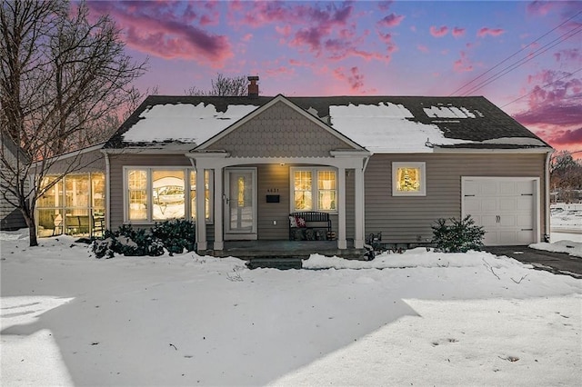 view of front of house featuring a porch and a garage