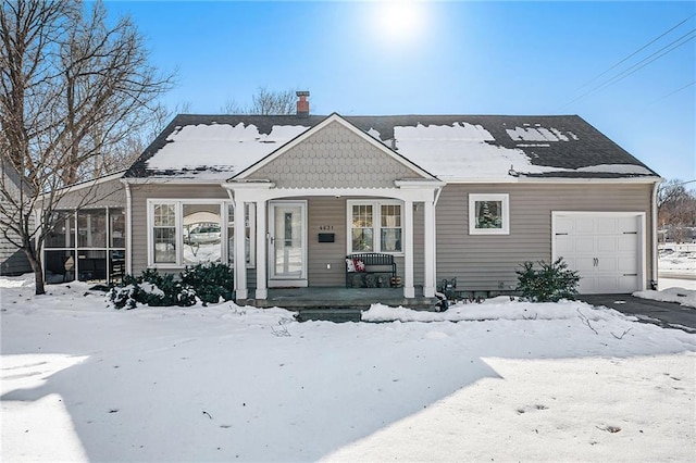 view of front of home featuring covered porch and a garage