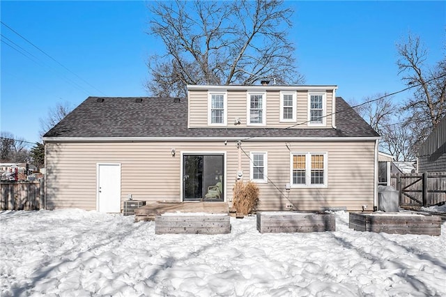 snow covered house with central AC