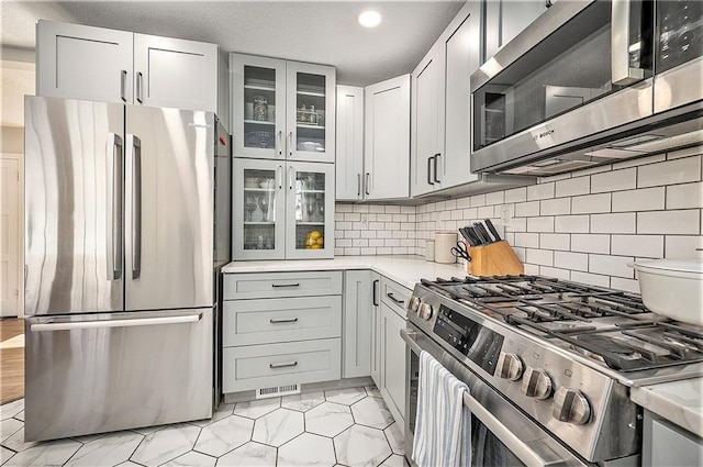 kitchen featuring appliances with stainless steel finishes and decorative backsplash