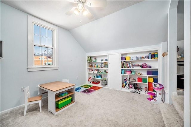 playroom with ceiling fan, carpet, and lofted ceiling