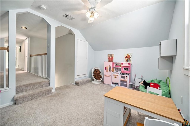 recreation room with lofted ceiling, light carpet, and ceiling fan