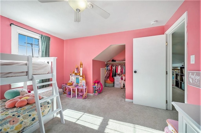 carpeted bedroom with ceiling fan and a closet