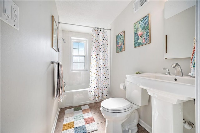 bathroom featuring toilet, tile patterned flooring, and shower / bath combo