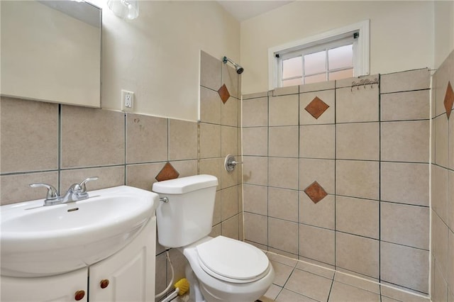 bathroom featuring tile walls, toilet, and vanity