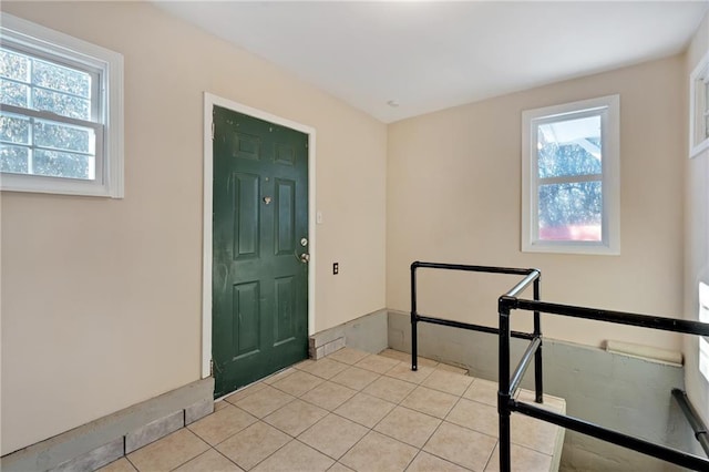 foyer entrance featuring light tile patterned flooring