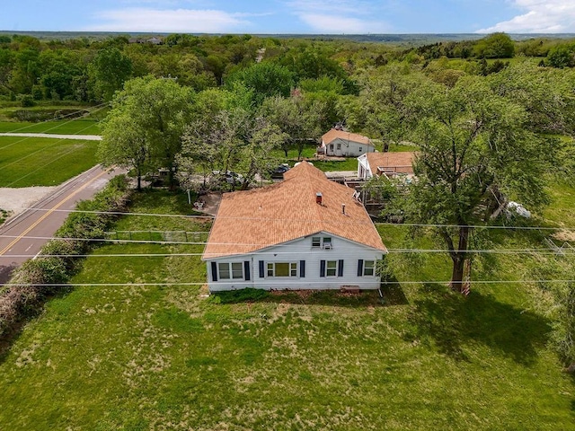 birds eye view of property featuring a view of trees