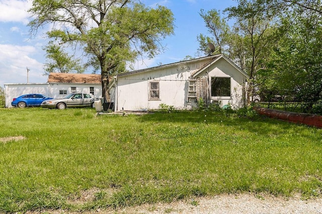 rear view of property with a lawn