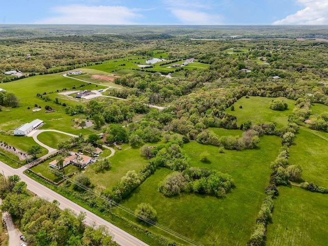 drone / aerial view featuring a wooded view