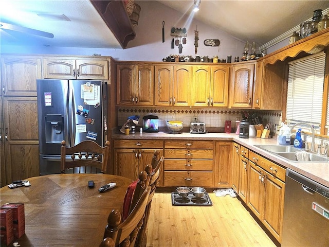 38708 E Hudson Rd, Oak Grove, MO 64075 - kitchen with stainless steel appliances, light wood-style floors, vaulted ceiling, light countertops, and tasteful backsplash