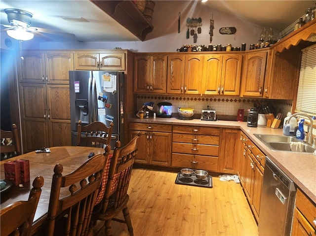 38708 E Hudson Rd, Oak Grove, MO 64075 - kitchen featuring appliances with stainless steel finishes, a ceiling fan, light wood-style flooring, lofted ceiling, and brown cabinets