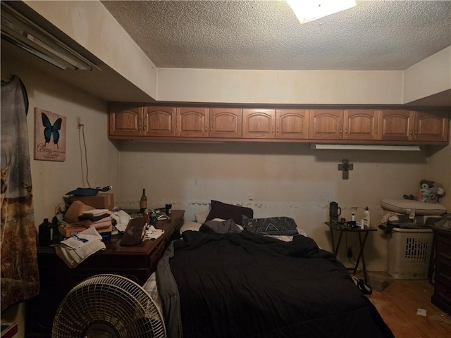 38708 E Hudson Rd, Oak Grove, MO 64075 - bedroom featuring wood finished floors and a textured ceiling