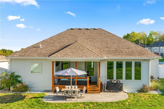 rear view of house featuring a patio and a lawn